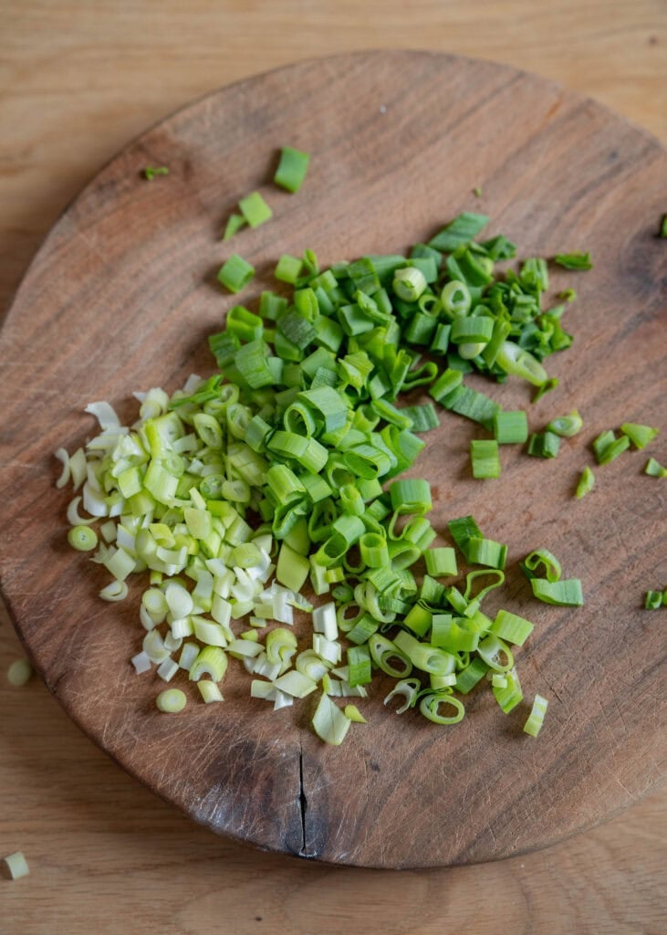 sliced scallions on cutting board
