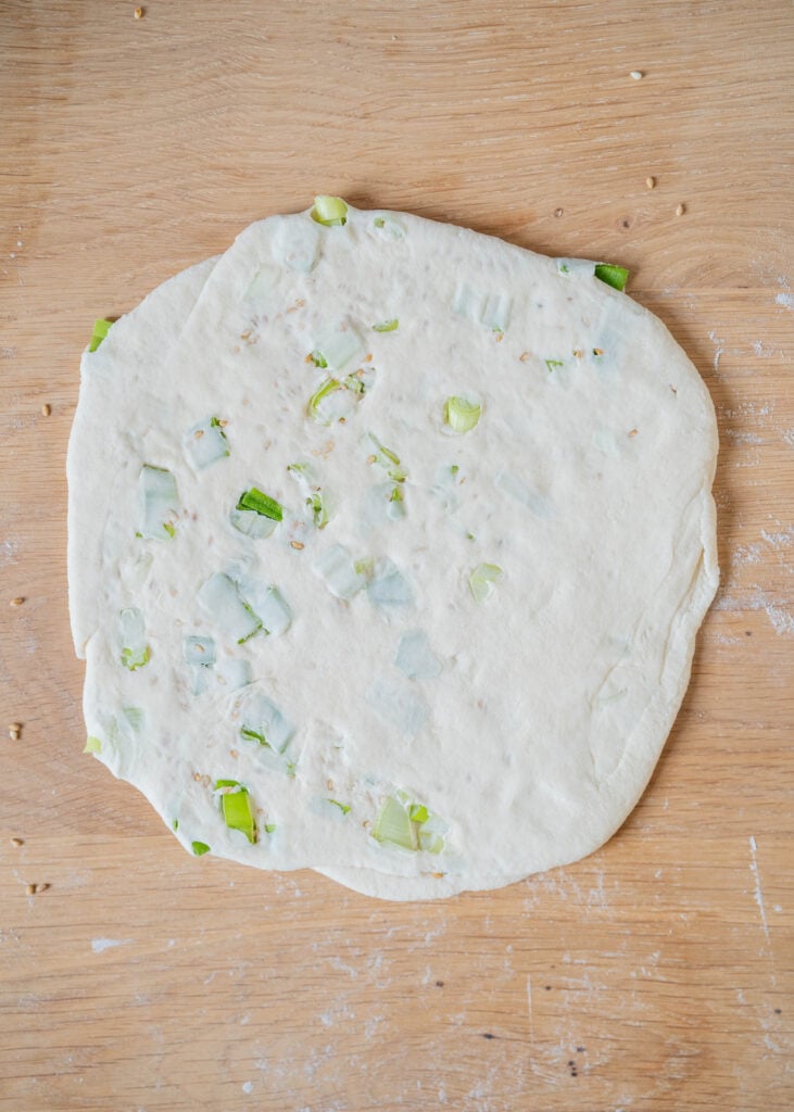 rolling out dough into pancake circle