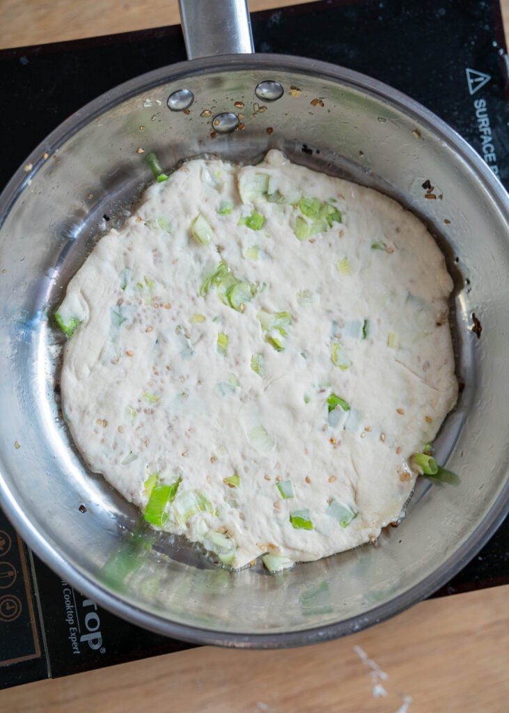 uncooked ourdough discard scallion pancake in pan