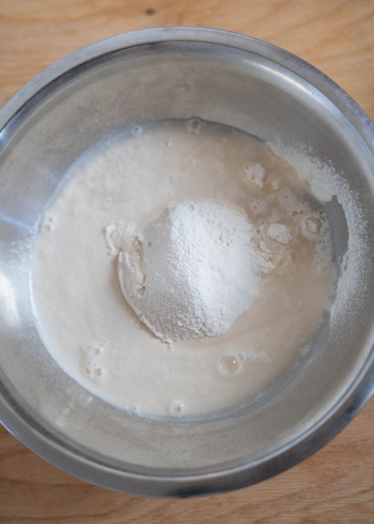 warm water, sourdough discard, flour in bowl