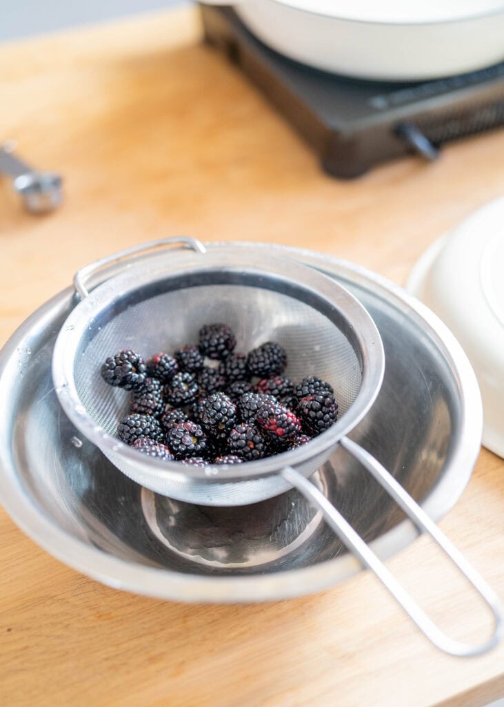 straining blackberries