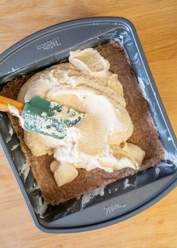 adding cheesecake layer to crust in pan