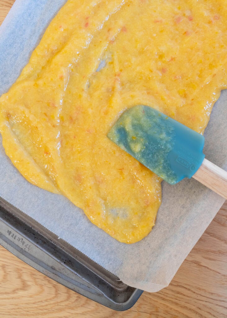 spreading fruit leather mixture