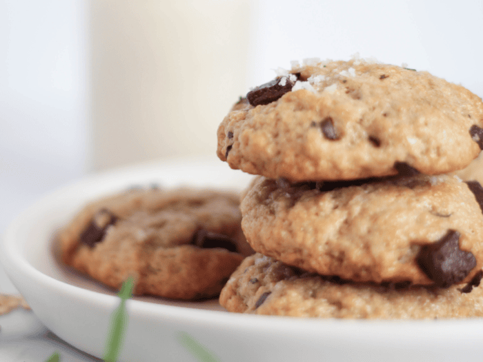 stack of oat pulp cookies on a plate with sprig of rosemary